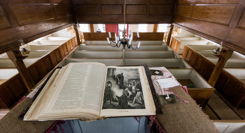 Book resting on a podium overlooking a historic meeting room